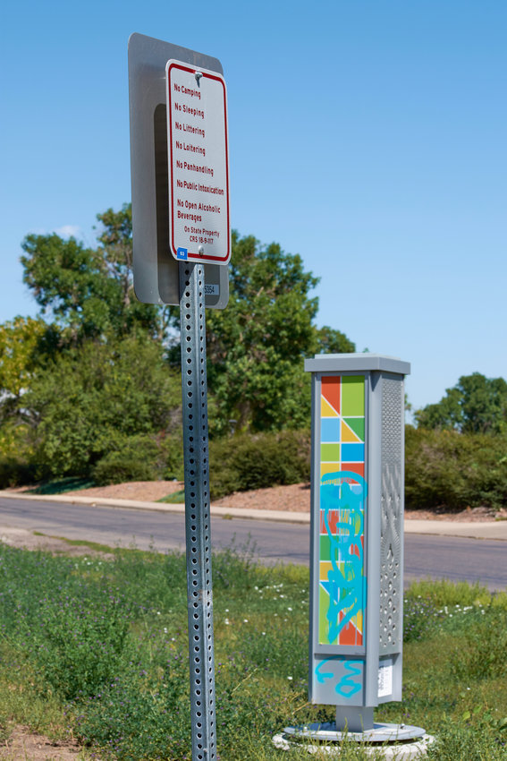 A small totem guide for the ArtLine with QR codes for the audio tour stands near Aviation Park, and beside a sign that reads, among other things, "No Loitering."